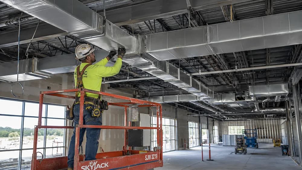 Contractor working on duct